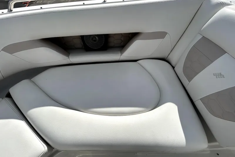 Slide: The Image of 2018 Four Winns HD240 boat interior seating with white upholstery and speaker. - 82