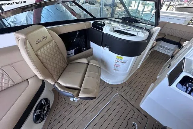 Slide: The Image of Interior of a 2019 Sea Ray SLX 250 boat with tan leather seating and modern amenities. - 10