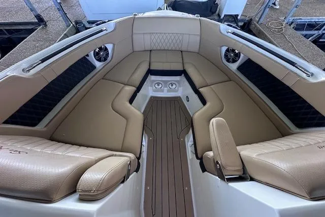 Slide: The Image of Interior of 2019 Sea Ray SLX 250 boat with tan leather seating and wood flooring. - 12