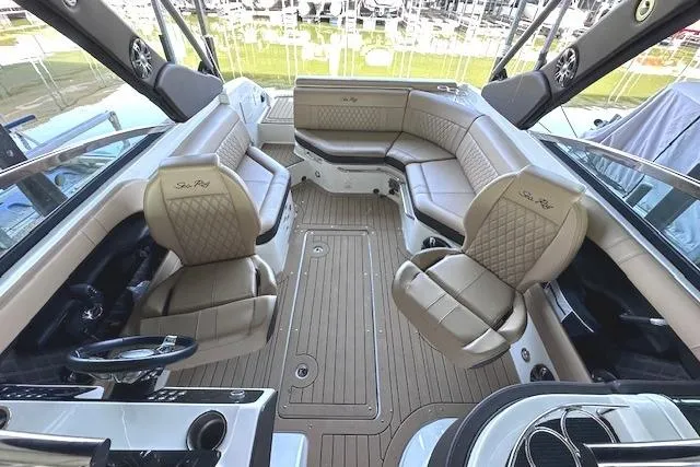 Slide: The Image of Luxurious interior of 2019 Sea Ray SLX 250 boat with elegant seating and wood flooring. - 14