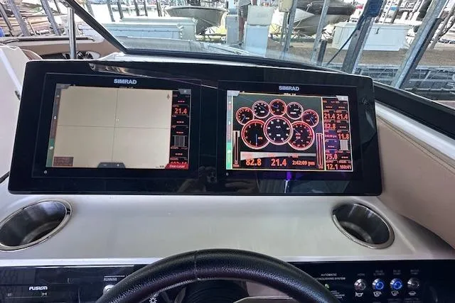 Slide: The Image of Dashboard of 2019 Sea Ray SLX 250 boat with Simrad navigation displays. - 17