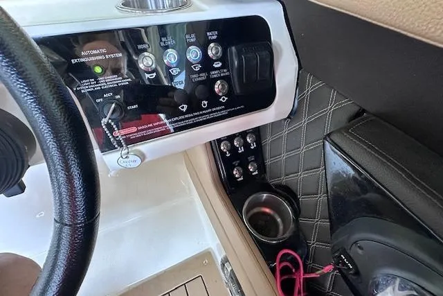 Slide: The Image of Control panel of 2019 Sea Ray SLX 250 boat with cup holder and switches. - 18