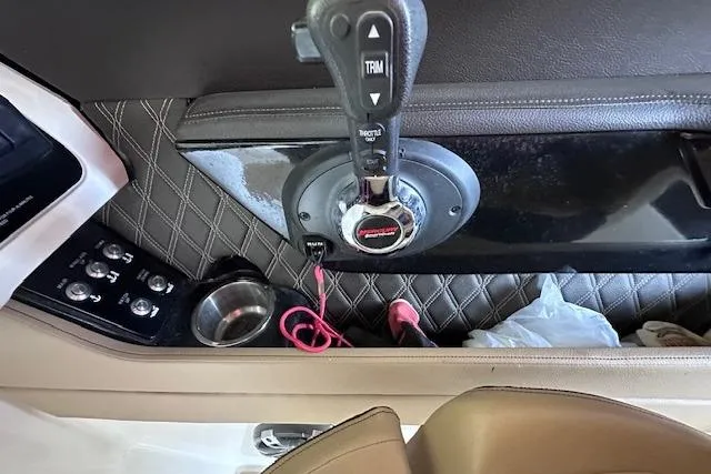 Slide: The Image of 2019 Sea Ray SLX 250 boat control panel with throttle and trim controls. - 20