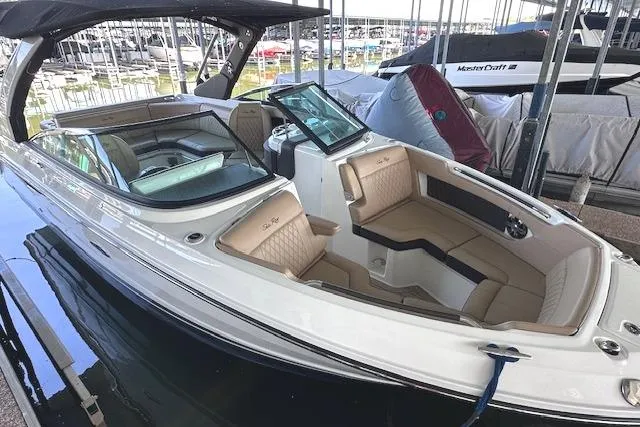 Slide: The Image of 2019 Sea Ray SLX 250 boat with sleek design and spacious seating in marina. - 3