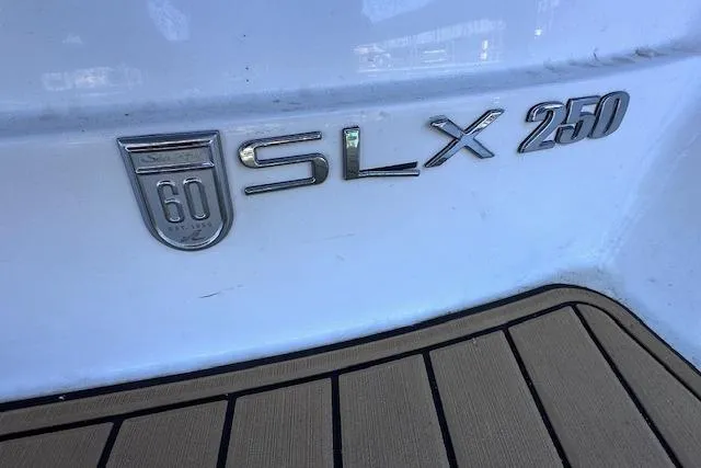 Slide: The Image of 2019 Sea Ray SLX 250 boat emblem on white hull with teak flooring. - 5