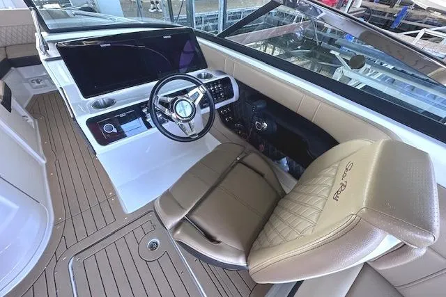 Slide: The Image of 2019 Sea Ray SLX 250 boat interior with steering wheel and luxurious seating. - 9