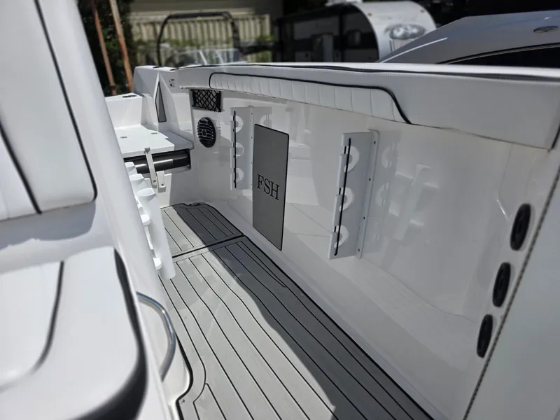 Slide: The Image of The image shows the deck of a 2026 Yamaha 222 FSH Sport E boat with gray flooring. - 17