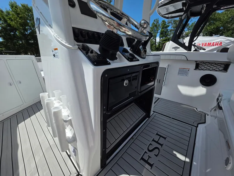 Slide: The Image of The cockpit of the 2026 Yamaha 222 FSH Sport E features a modern helm and storage area. - 19