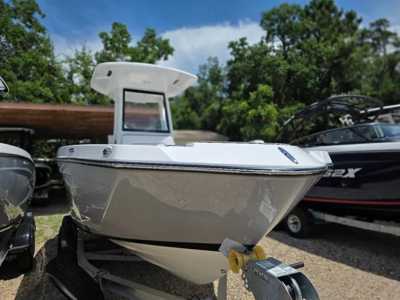 Slide: The Image of Yamaha Boats 222 FSH Sport E 2026 in a sunny outdoor setting, surrounded by trees. - 2