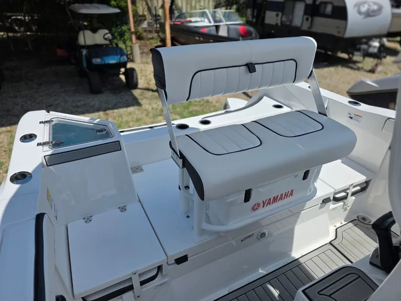 Slide: The Image of The image shows the cockpit of a Yamaha 222 FSH Sport E boat with a cushioned bench seat. - 24