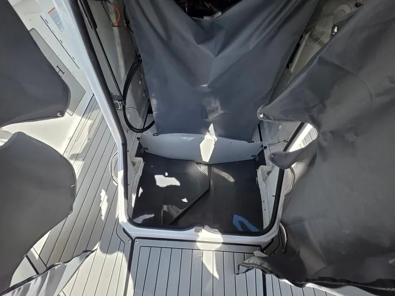 Slide: The Image of Interior of a 2026 Yamaha 222 FSH Sport E boat with gray covers. - 15