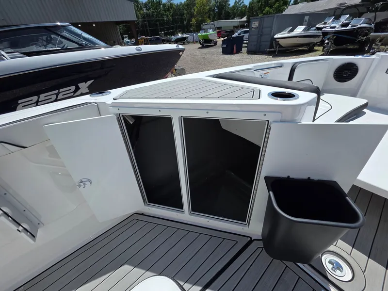 Slide: The Image of The image shows the storage area of a 2026 Yamaha 222 FSH Sport E boat with open doors. - 22
