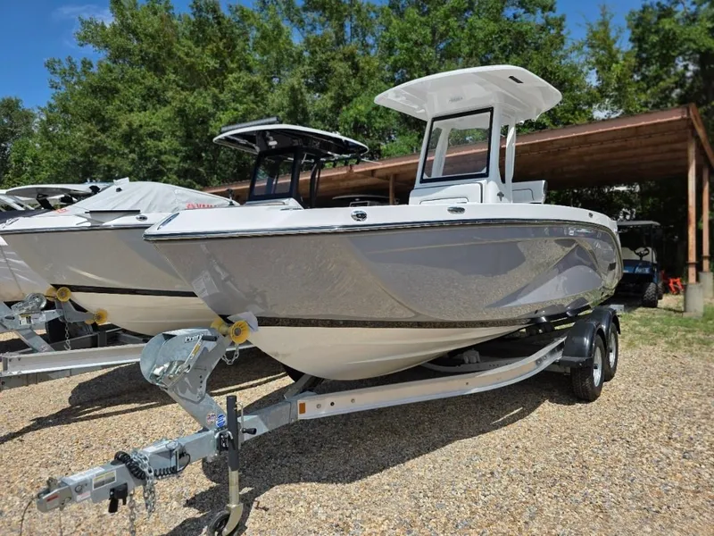 Slide: The Image of Yamaha Boats 222 FSH Sport E 2026 on a trailer, surrounded by trees and other boats. - 42