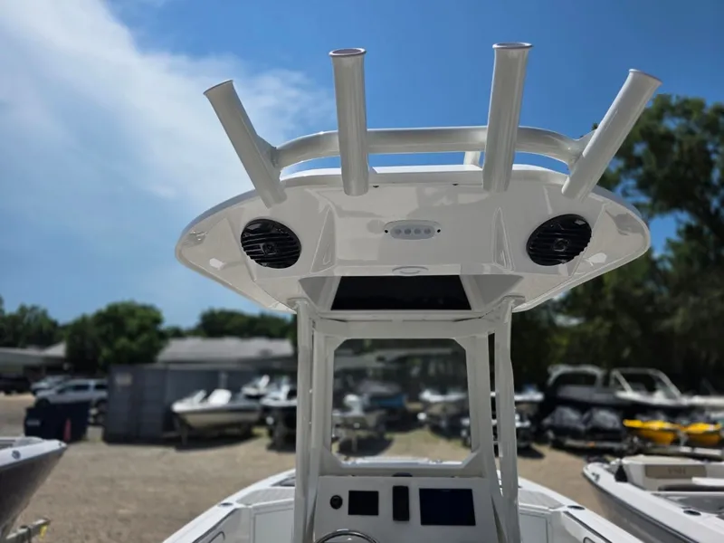 Slide: The Image of Yamaha Boats 222 FSH Sport E 2026: Helm with speakers and rod holders, surrounded by boats. - 12