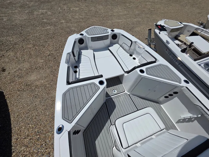 Slide: The Image of The image shows the deck of a 2026 Yamaha 222 FSH Sport E boat with gray upholstery. - 8