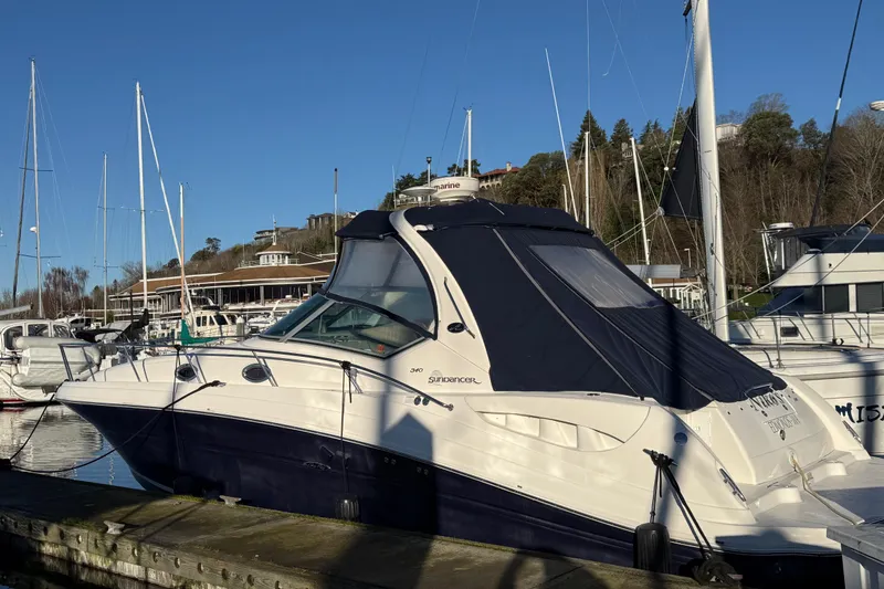 The Image of 2007 Sea Ray 340 boat docked at marina under clear blue sky. - 1