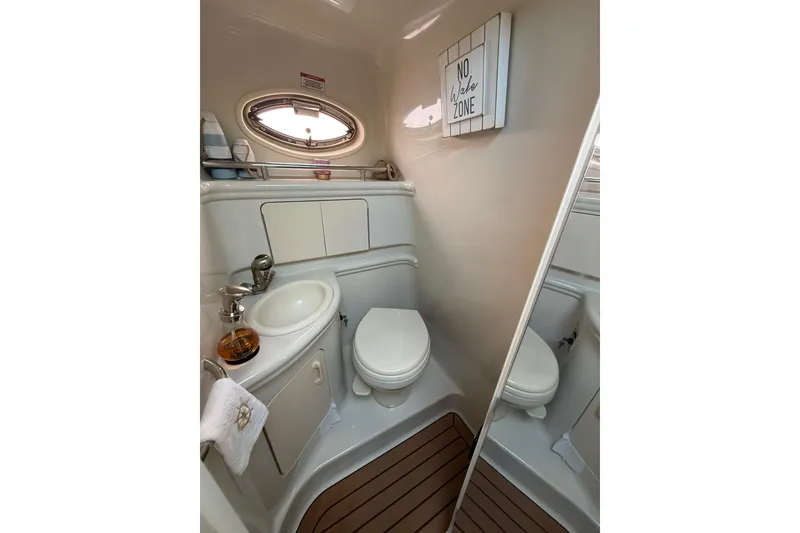 Slide: The Image of 2007 Sea Ray 340 yacht bathroom with sink, toilet, and "No Wake Zone" sign. - 20