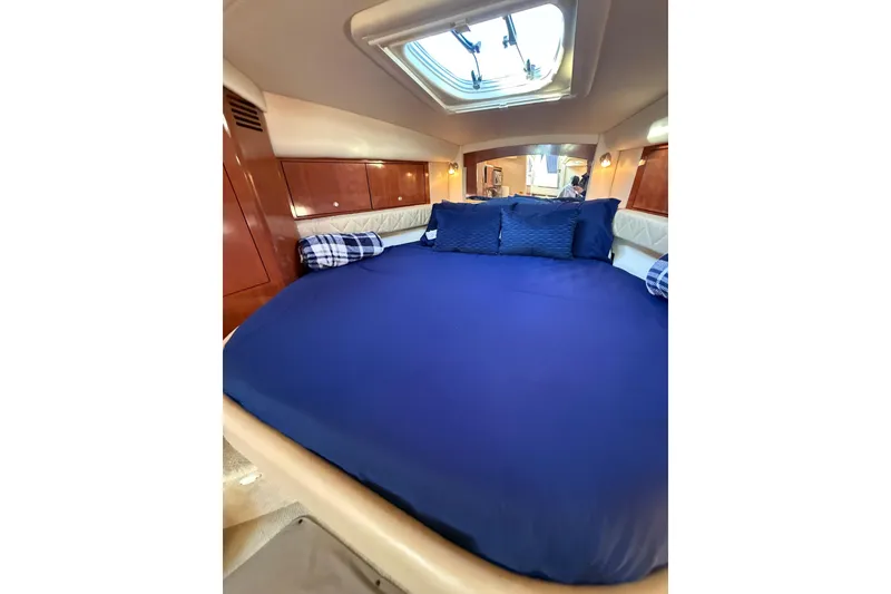 Slide: The Image of Luxurious cabin interior of 2007 Sea Ray 340 yacht with blue bedding and wood accents. - 3