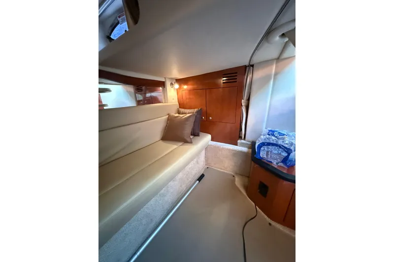 Slide: The Image of Interior of 2007 Sea Ray 340 boat with beige seating and wooden cabinetry. - 4