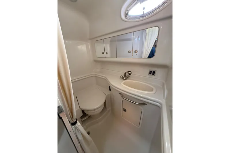 Slide: The Image of 2007 Sea Ray 340 yacht bathroom with sink, toilet, and mirrored cabinet. - 6