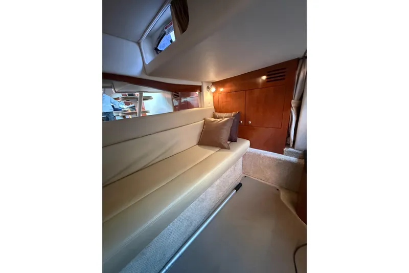 Slide: The Image of Interior of 2007 Sea Ray 340 yacht with beige seating and wooden cabinetry. - 7