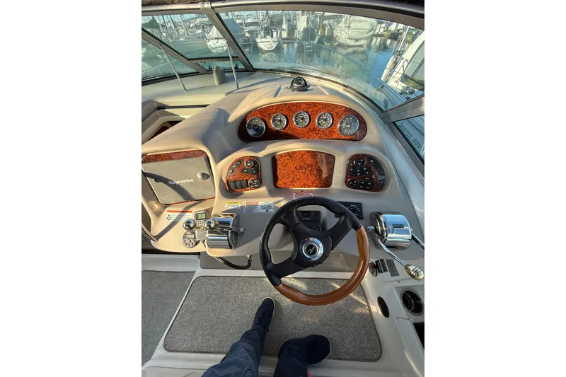 Slide: The Image of 2007 Sea Ray 340 boat helm with wood accents and modern controls. - 9