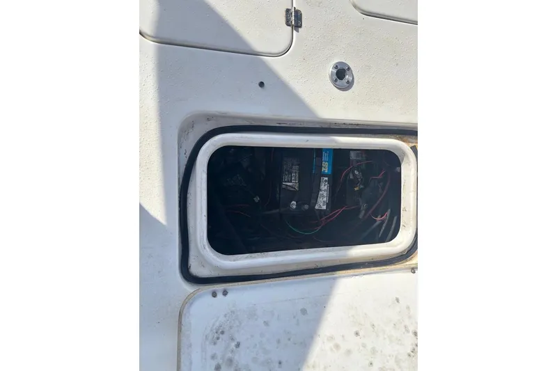 Slide: The Image of Open battery compartment on a 2004 Palmetto 22 boat. - 10