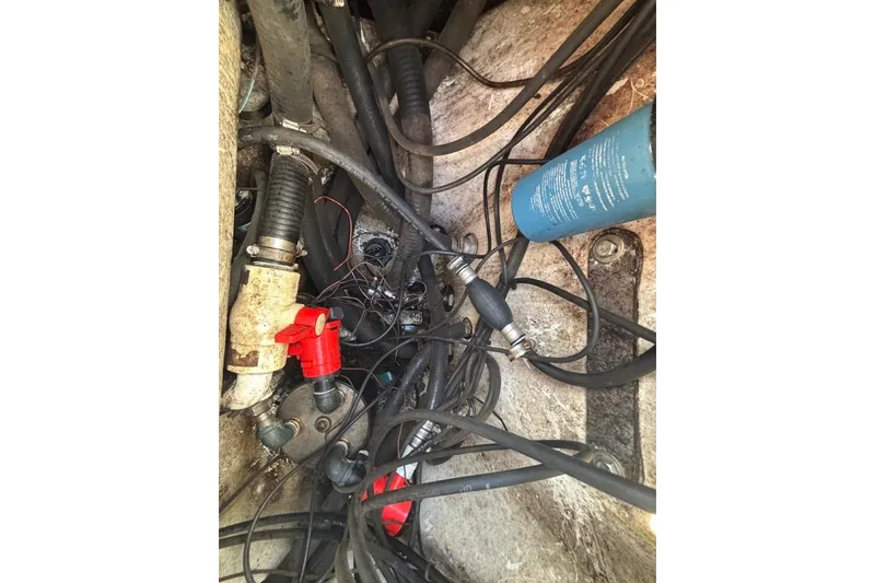 Slide: The Image of Engine compartment of a 2004 Palmetto 22 boat with hoses and components. - 11