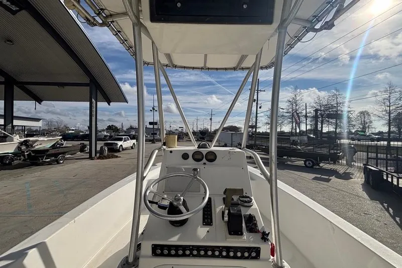 Slide: The Image of 2004 Palmetto 22 boat cockpit with steering wheel and controls, parked outdoors. - 14