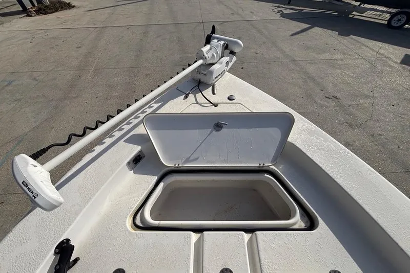 Slide: The Image of 2004 Palmetto 22 boat with open storage compartment and trolling motor. - 17