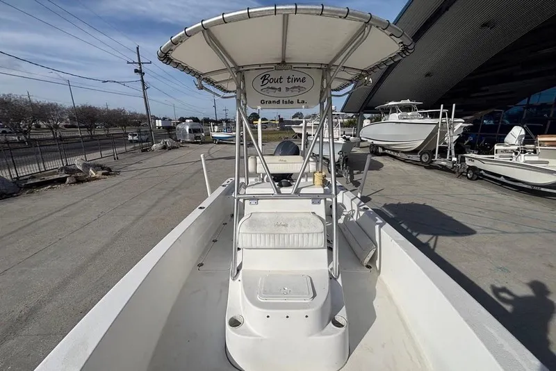 Slide: The Image of 2004 Palmetto 22 boat with canopy, parked at a marina. - 19