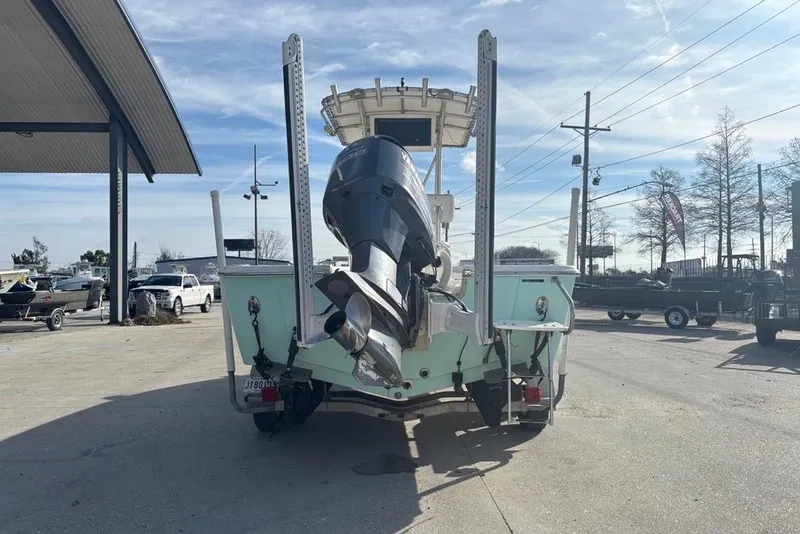 Slide: The Image of 2004 Palmetto 22 boat with outboard motor in a parking lot. - 4