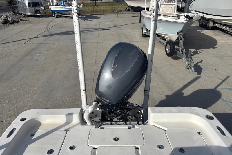 Slide: The Image of 2004 Palmetto 22 boat with outboard motor in a marina setting. - 9
