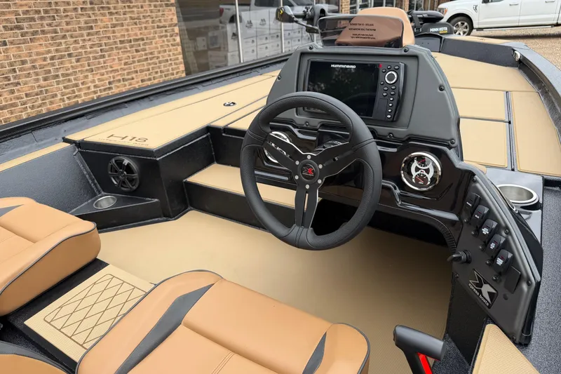 Slide: The Image of 2026 Xpress H18 boat interior with steering wheel, control panel, and tan seating. - 5