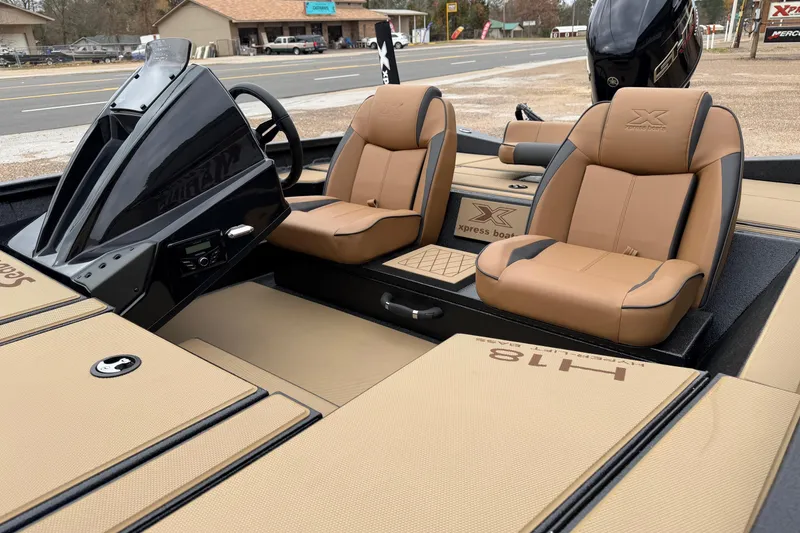 Slide: The Image of 2026 Xpress H18 boat interior with tan seats and modern dashboard design. - 7