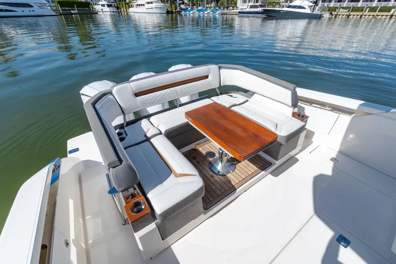 Slide: The Image of Luxurious seating area on 2020 Tiara Sport 38 LS boat, docked at marina. - 15