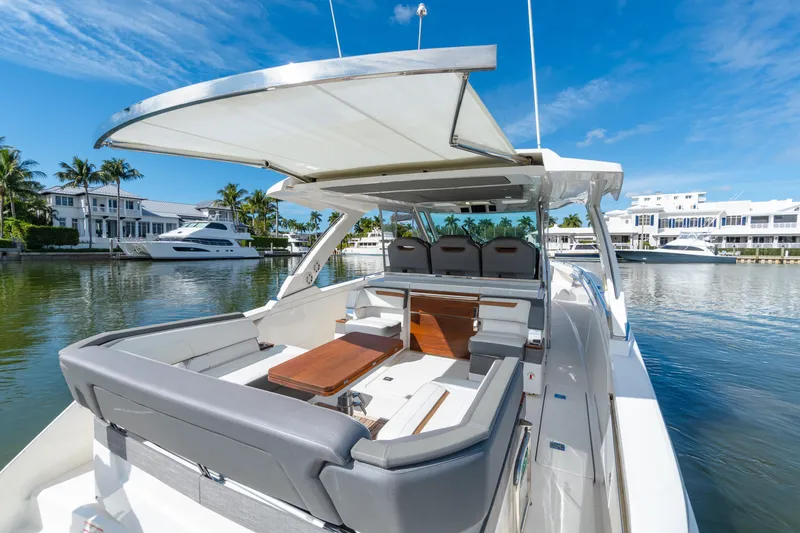 Slide: The Image of 2020 Tiara Sport 38 LS luxury yacht with spacious seating, docked in a scenic marina. - 18