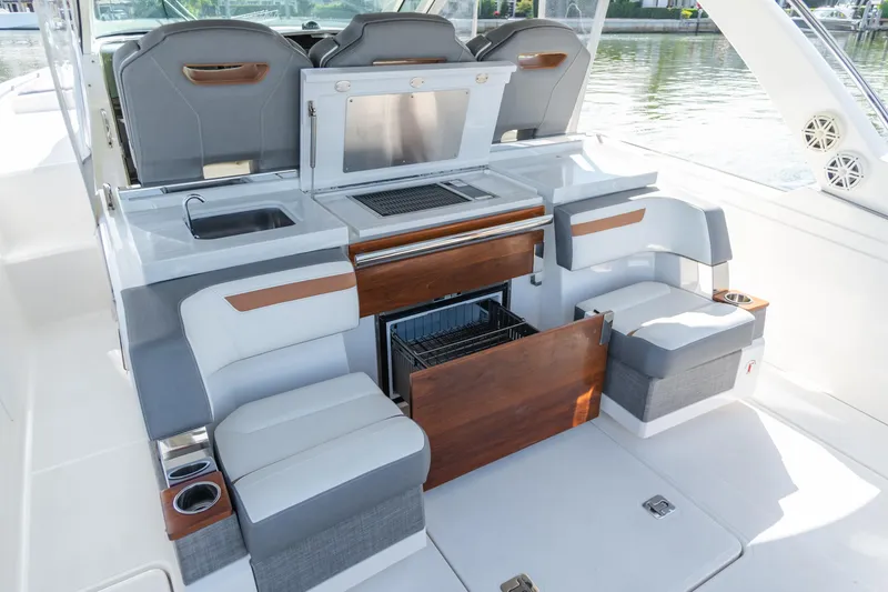 Slide: The Image of 2020 Tiara Sport 38 LS boat interior with seating, sink, and storage. - 19