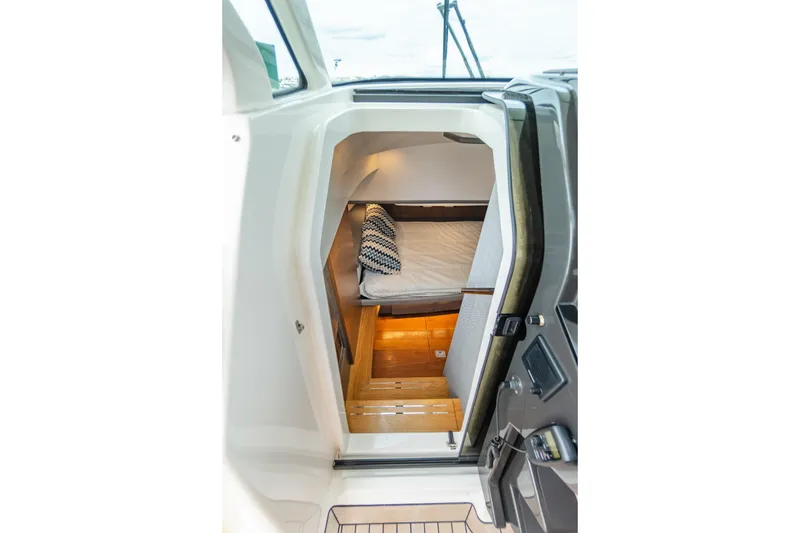 Slide: The Image of 2020 Tiara Sport 38 LS cabin interior with cozy bed and wooden flooring. - 25