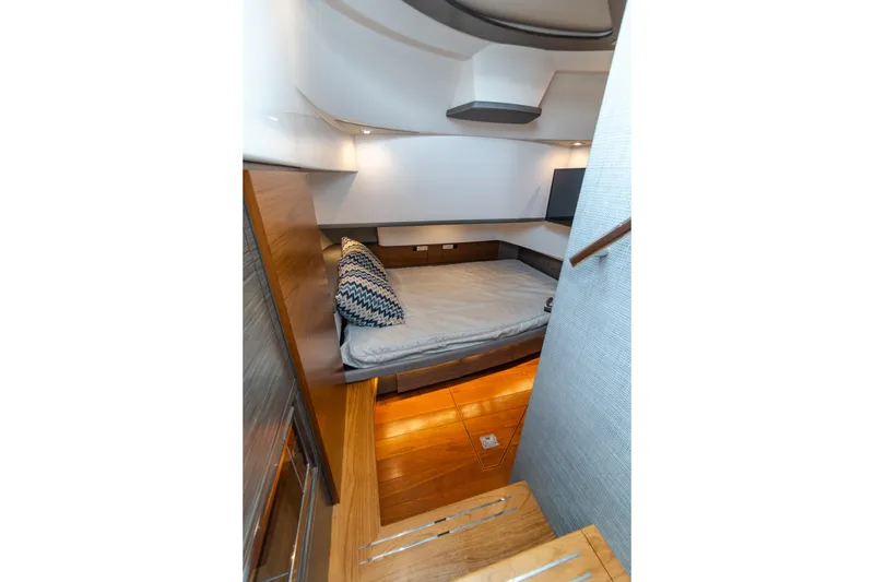 Slide: The Image of 2020 Tiara Sport 38 LS cabin interior with bed, wooden flooring, and modern design. - 26