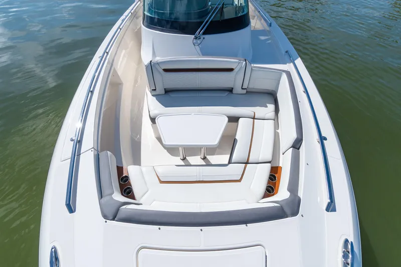 Slide: The Image of 2020 Tiara Sport 38 LS boat with luxurious seating and table on calm water. - 33
