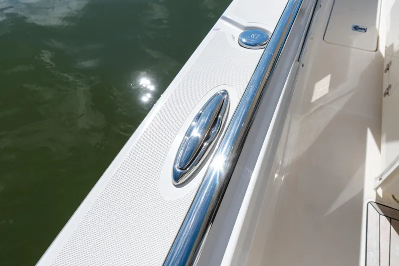 Slide: The Image of 2020 Tiara Sport 38 LS boat deck with chrome railing and water reflection. - 35