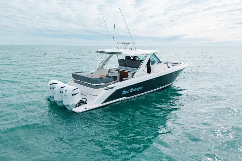 Slide: The Image of 2020 Tiara Sport 38 LS boat on open water, featuring triple Yamaha engines. - 5