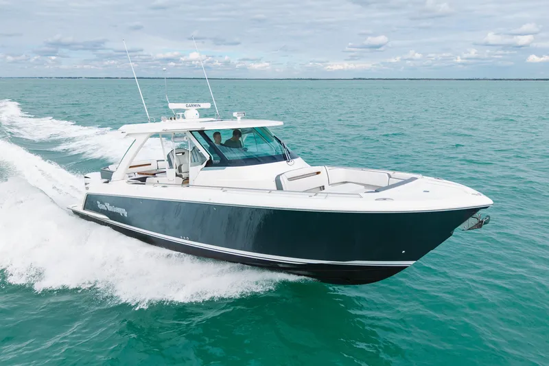 Slide: The Image of 2020 Tiara Sport 38 LS cruising on open water under a cloudy sky. - 8