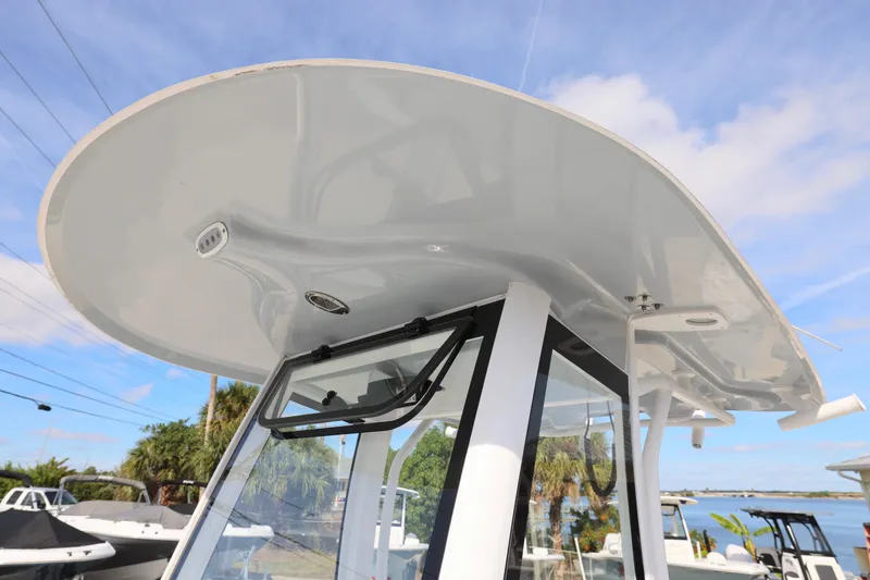 Slide: The Image of 2026 Sea Hunt Ultra 265 SE boat with sleek hardtop and clear sky background. - 17