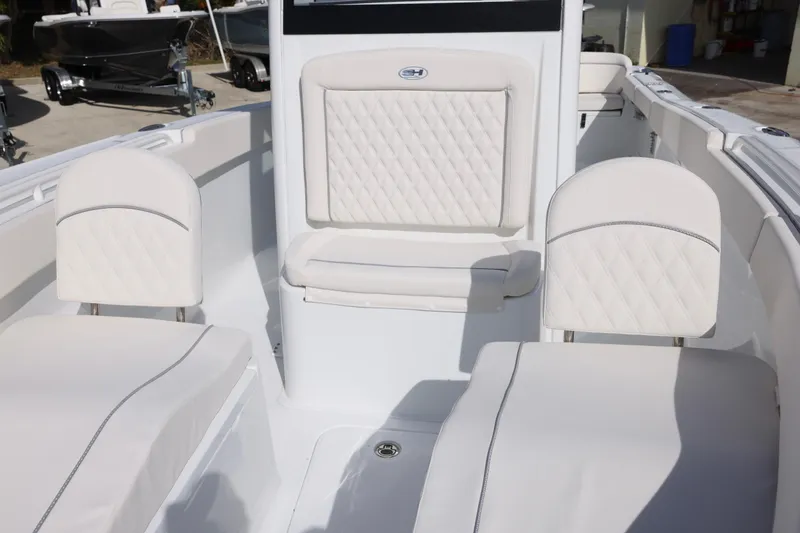 Slide: The Image of 2026 Sea Hunt Ultra 265 SE boat interior with white cushioned seating. - 18