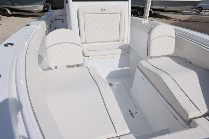Slide: The Image of 2026 Sea Hunt Ultra 265 SE boat interior with white cushioned seating. - 20