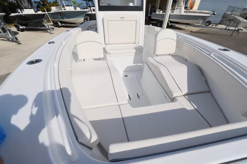 Slide: The Image of 2026 Sea Hunt Ultra 265 SE boat interior with white cushioned seating. - 21