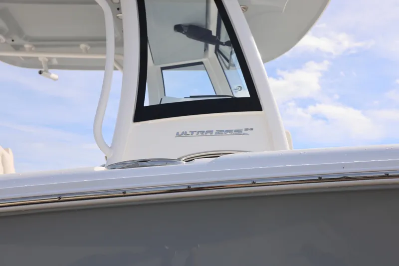 Slide: The Image of 2026 Sea Hunt Ultra 265 SE boat, sleek design under a clear sky. - 23