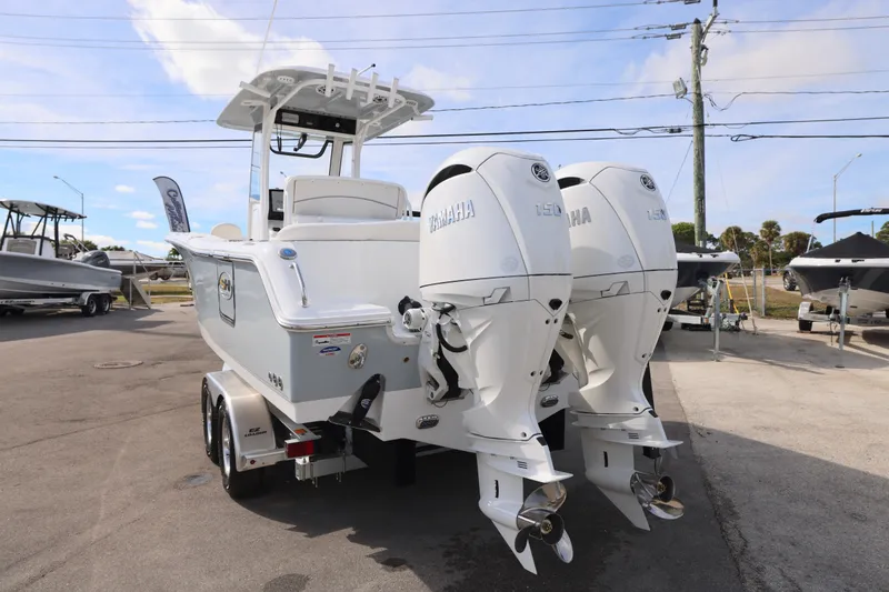 Slide: The Image of 2026 Sea Hunt Ultra 265 SE boat with dual Yamaha engines, parked on a trailer. - 25